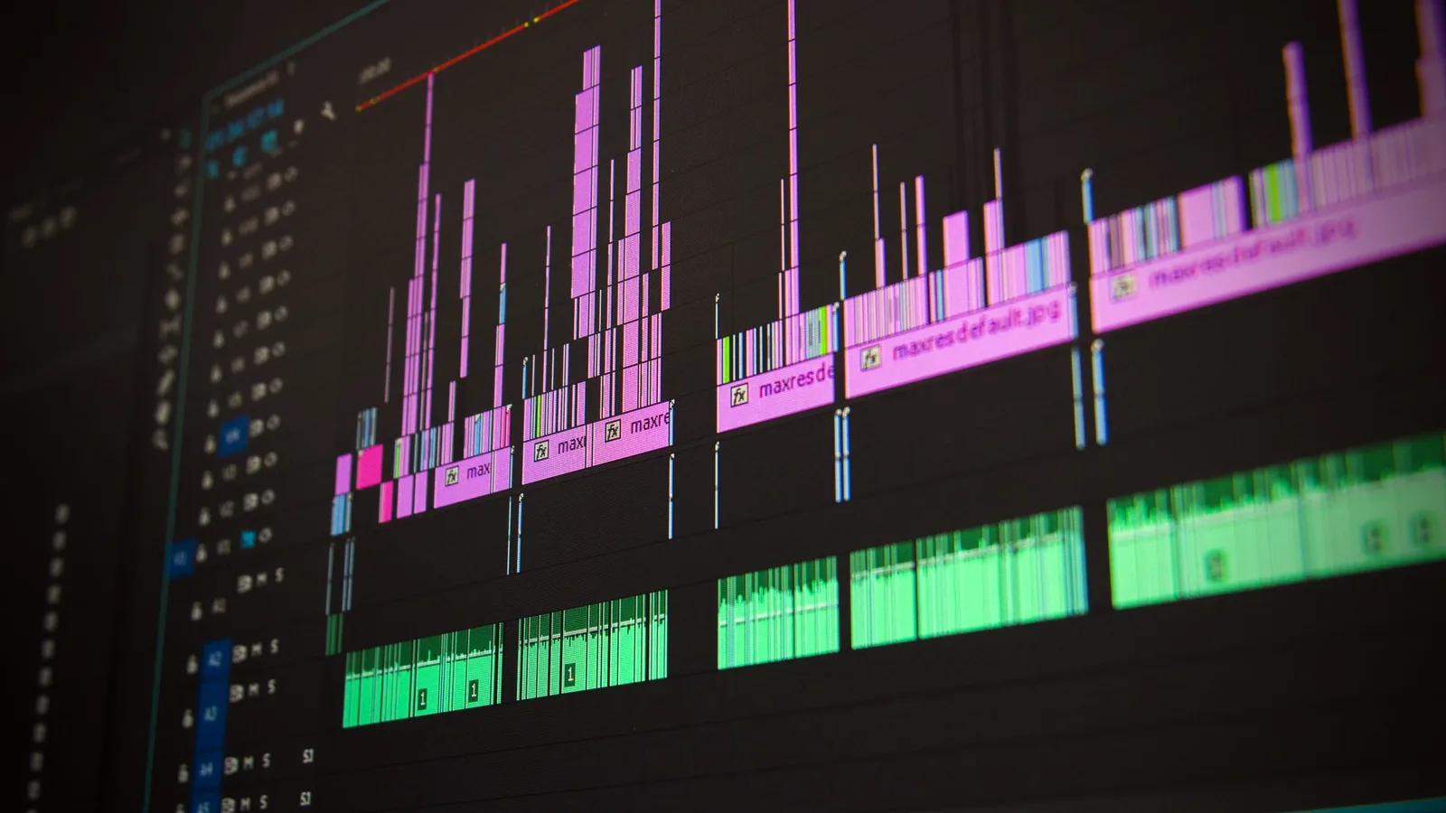 Video editing timeline with clip blocks and an audio waveform